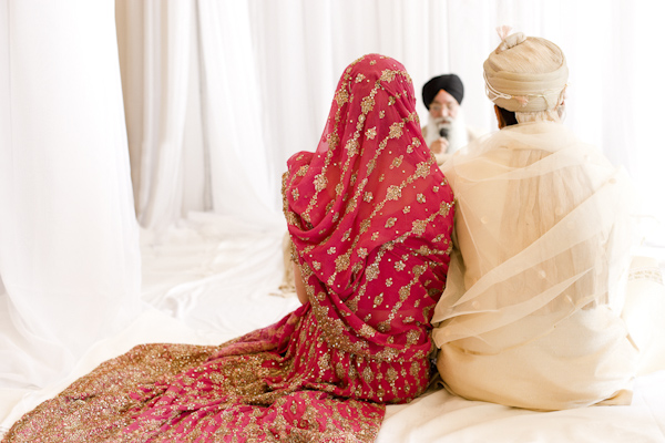East Indian bride and groom sitting together- wedding photo by top Canadian wedding photographer Rebecca Wood